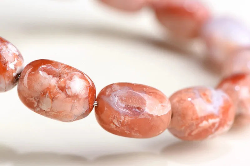 Natural cherry agate bracelet with 10x14mm barrel beads and Ruyi decorative elements
