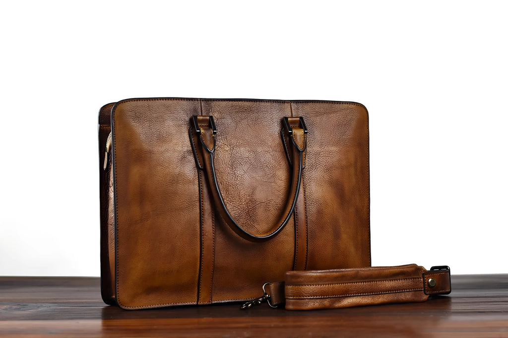 Men's brown leather retro handbag with horizontal square shape and zipper opening.