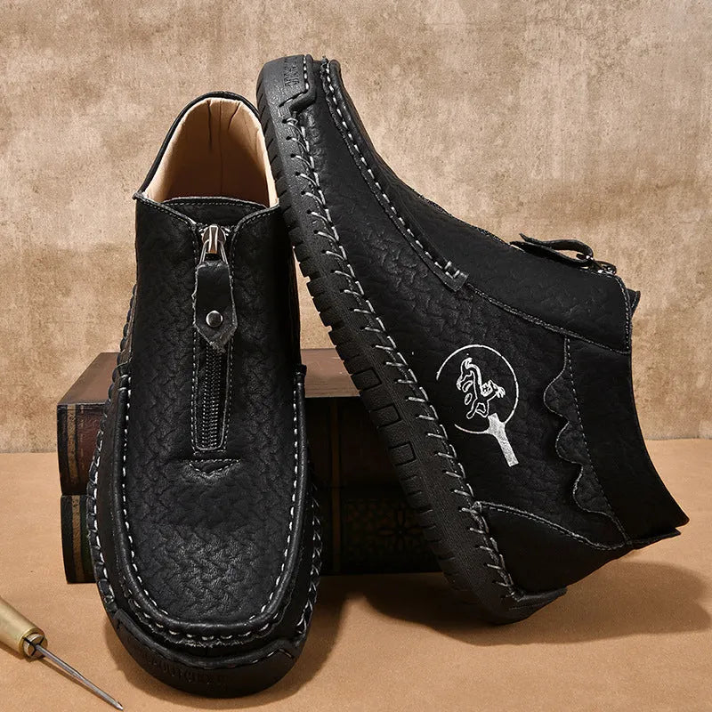 Men's black slip-on leather loafers with a round toe and flat rubber sole, shown on a foot.