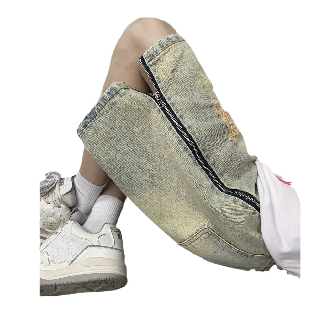 Men's loose five-point ripped denim shorts in blue with mud-yellow finish, button fly, and straight-leg cut