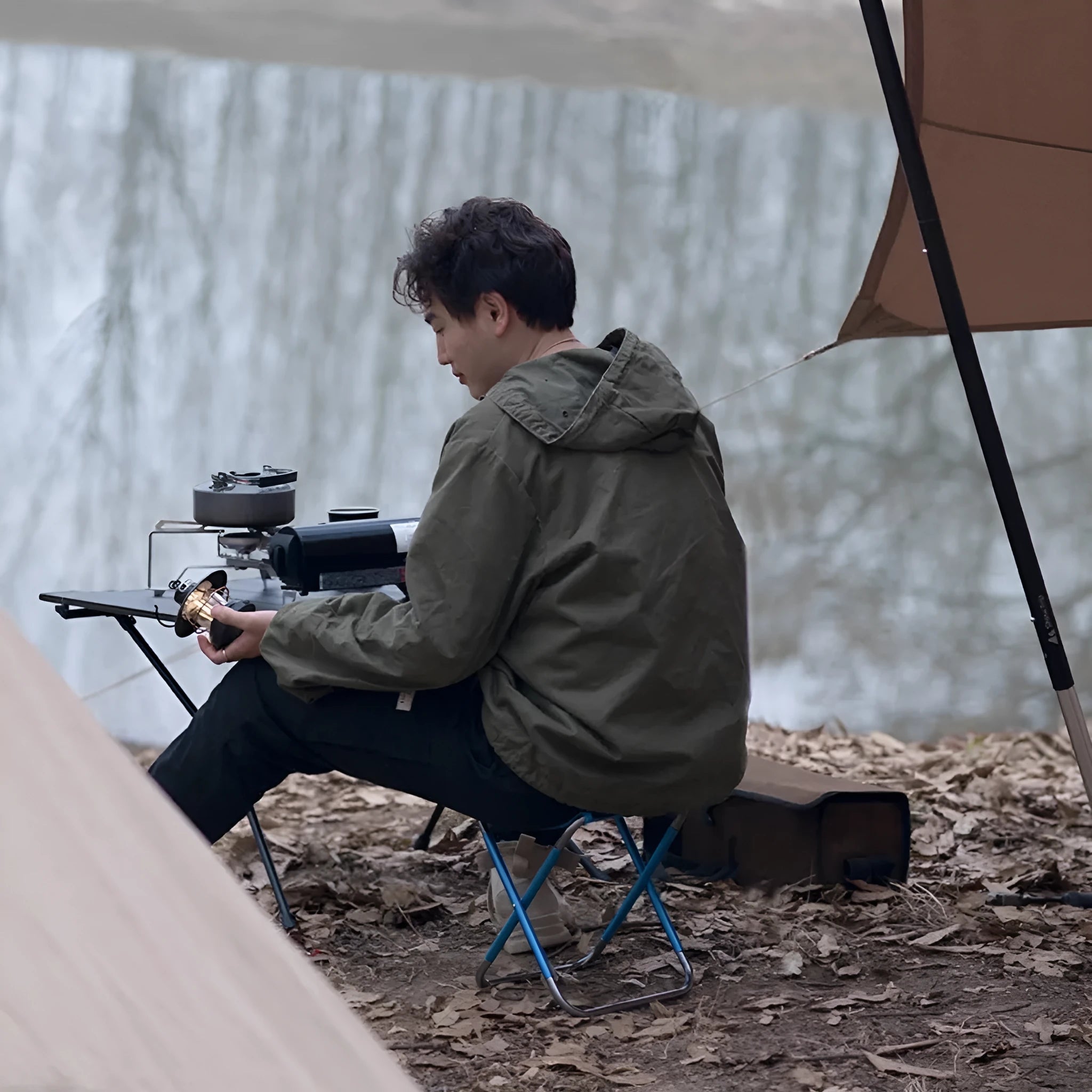 Black ethnic-style aluminium alloy portable folding stool shown in folded and unfolded positions.