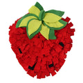 Red and green strawberry-shaped pet sniffing mat for dogs and cats on a wooden floor