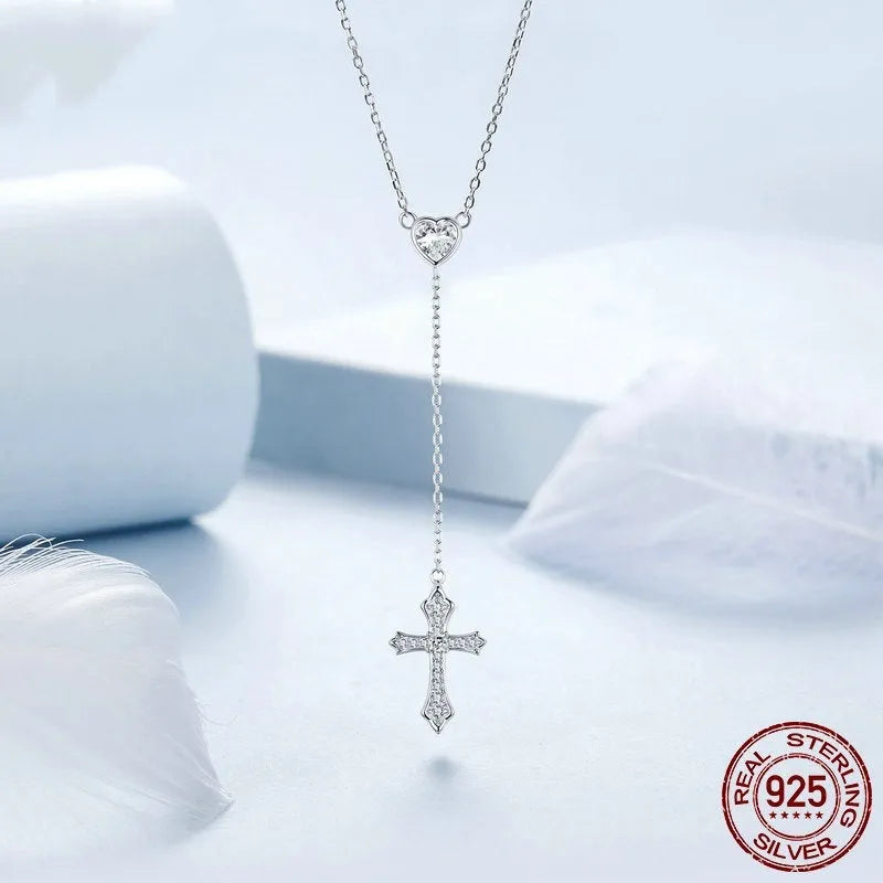 Simple sterling silver cross necklace with V-neck pendant on an O-ring chain.