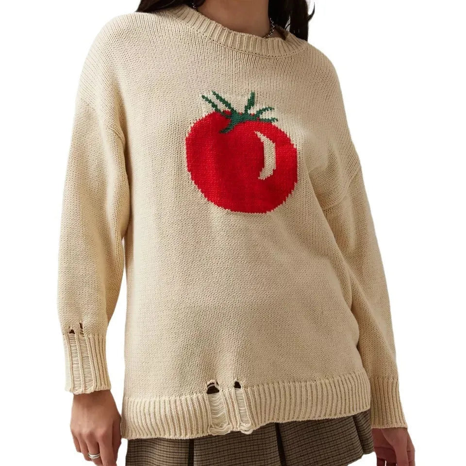 Women's loose-fitting beige jacquard knit sweater on a hanger, showing round neck and long sleeves.