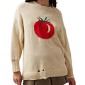 Women's loose-fitting beige jacquard knit sweater on a hanger, showing round neck and long sleeves.