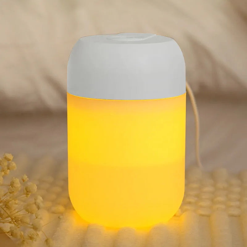 White cylindrical USB-powered mini humidifier on a desktop.