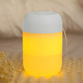 White cylindrical USB-powered mini humidifier on desk with charging cable