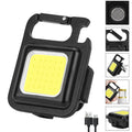 Black aluminium alloy keychain light with COB LED, magnetic base, and foldable handle on keyring
