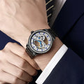 Men's mechanical business watch with transparent case back showing movement, available with leather or steel strap