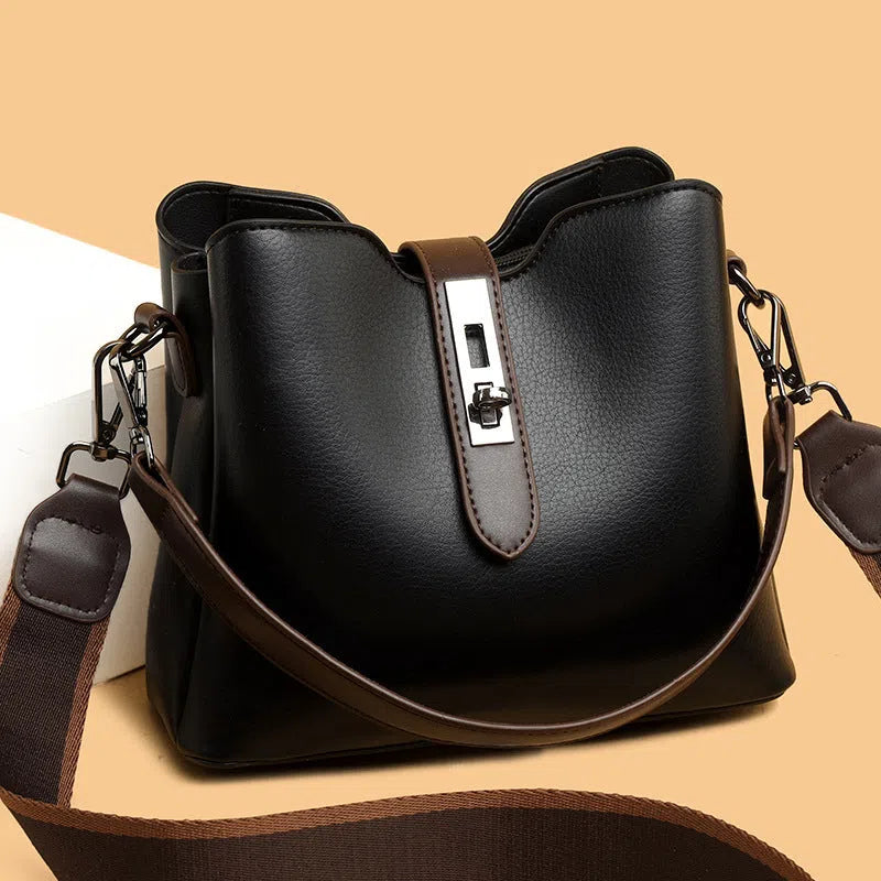 Textured PU bucket bag in black with patchwork stitching, horizontal rectangular shape, single shoulder strap.