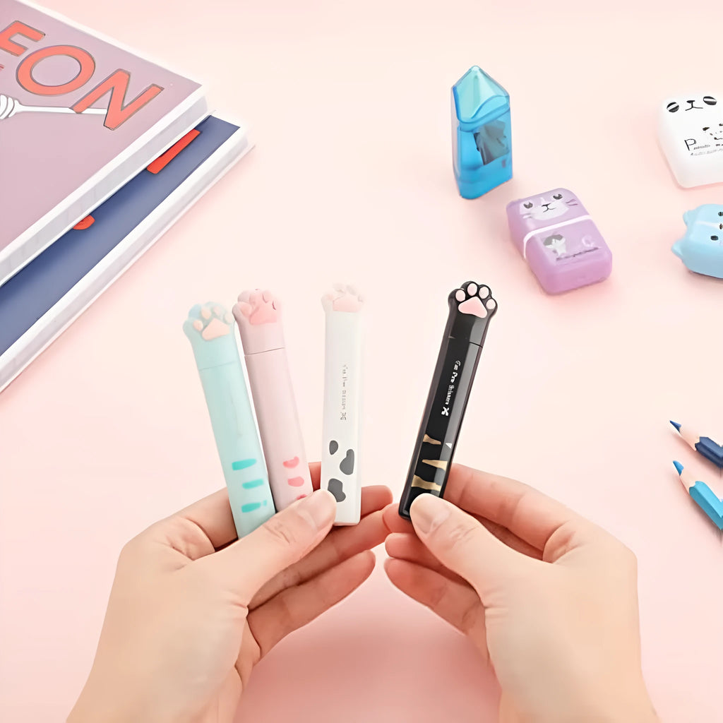 Small folding scissors with cat paw design on handles in choice of four colours, shown with blades safely closed.