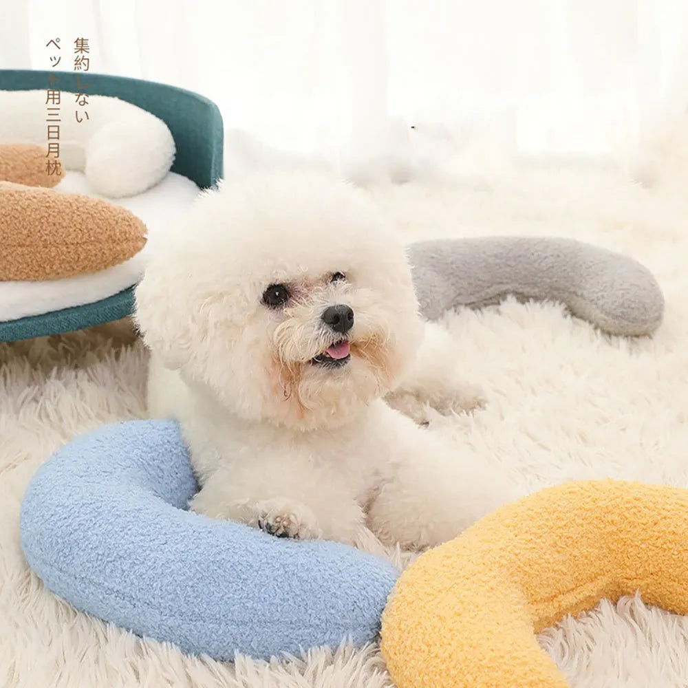 Blue U-shaped cat pillow with adjustable neck collar on sofa