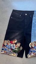 Men's blue cotton shorts with a printed design on the back pocket, showing tapered leg fit.