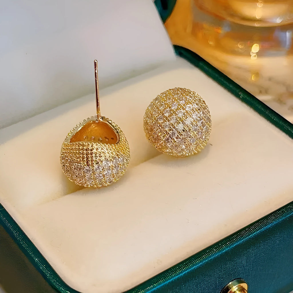 Gold and white geometric drop earrings with sphere elements and crystal embellishments