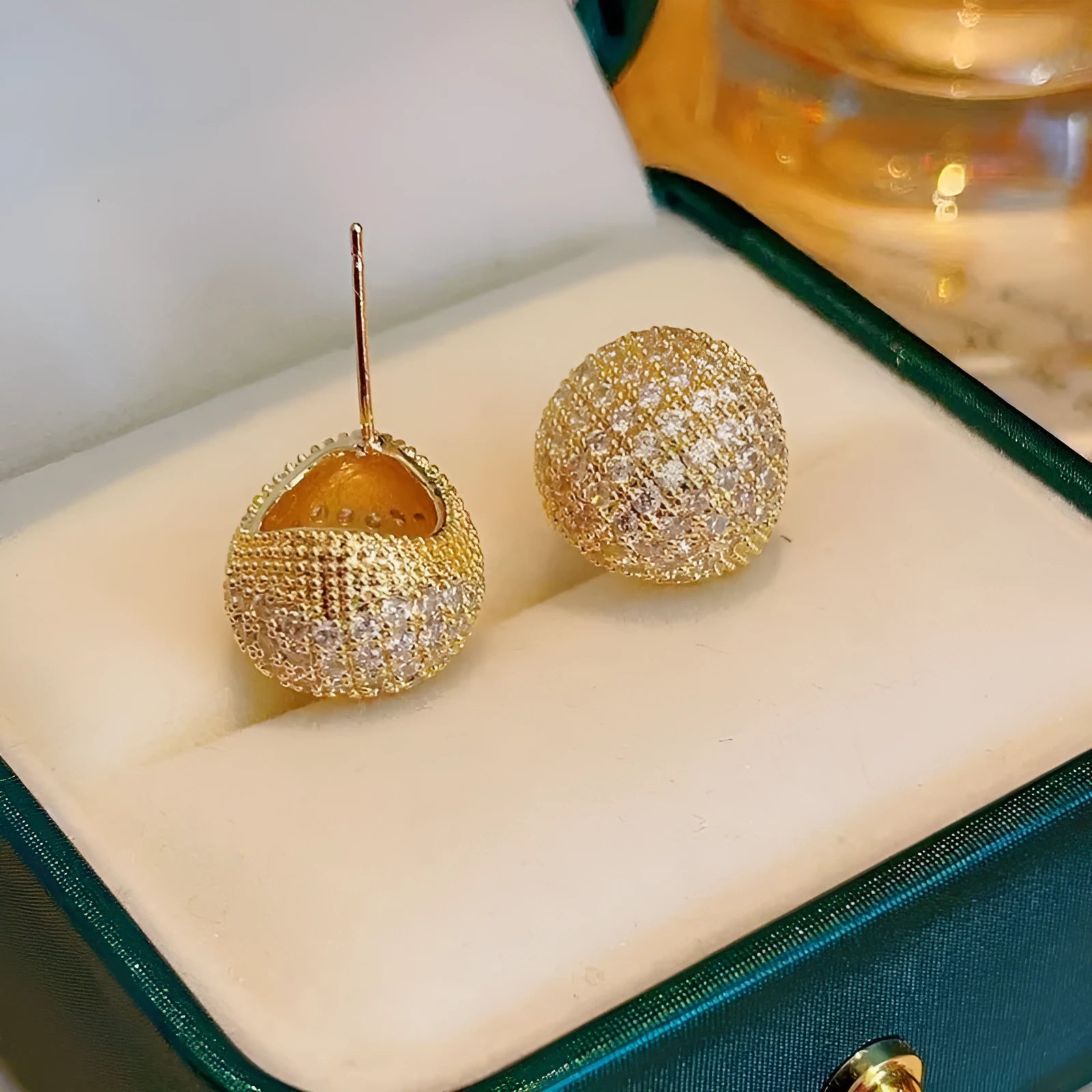 Gold and white geometric drop earrings with sphere elements and crystal embellishments