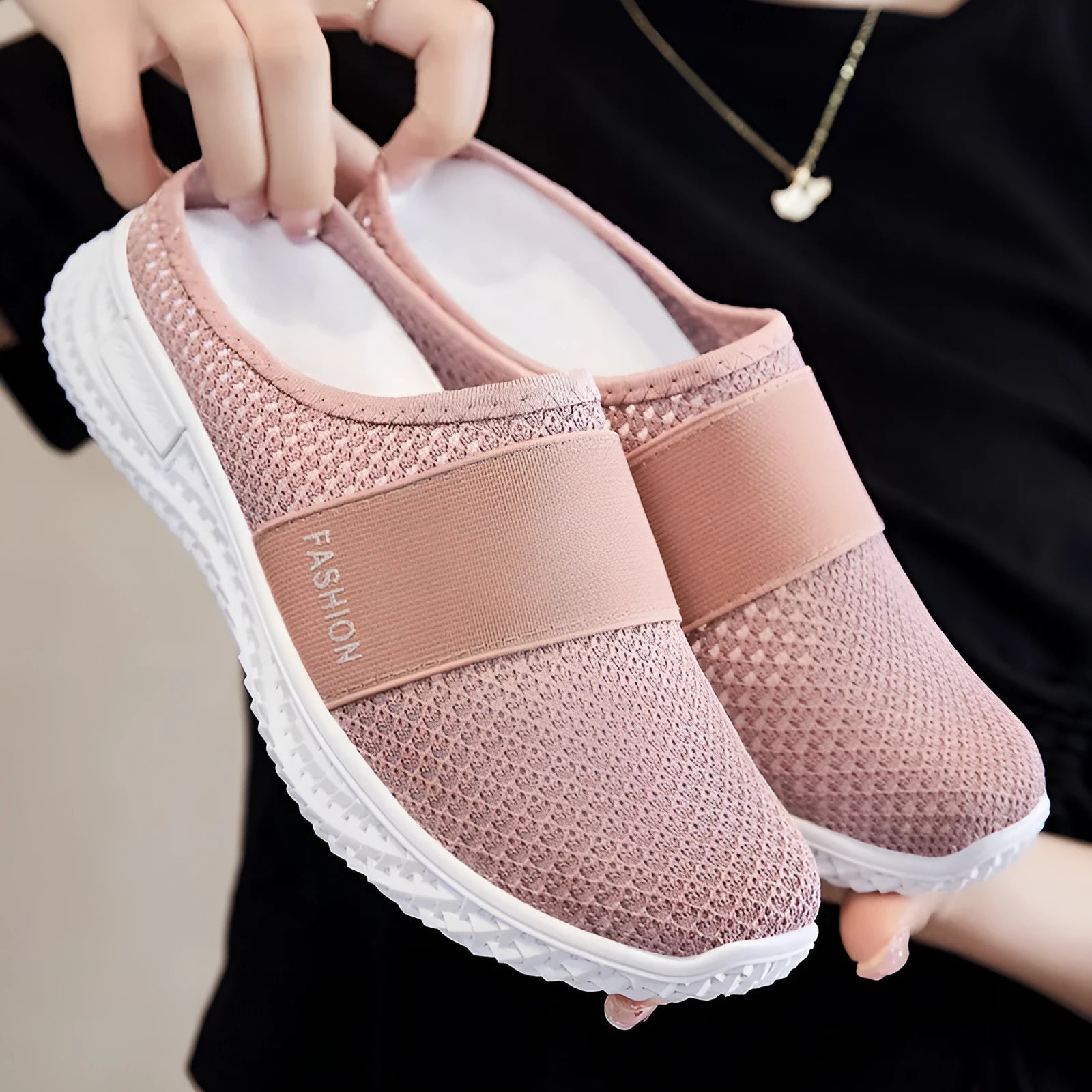 Women's breathable mesh casual shoes in black with a hollow out design and flat heel.