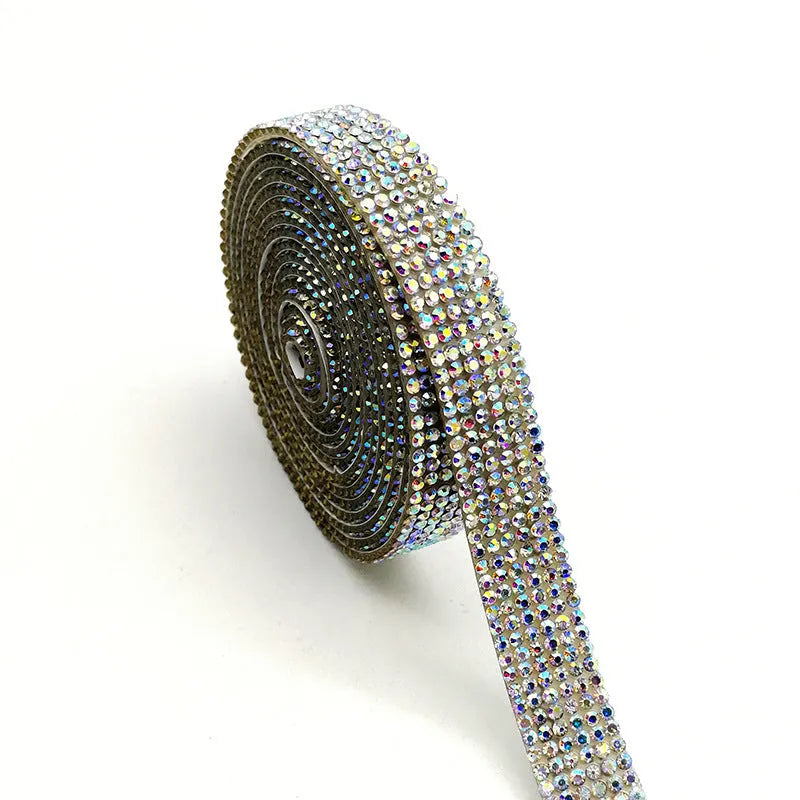 Long glass strip with self-adhesive backing for clothing decoration, shown in white and AB colour.