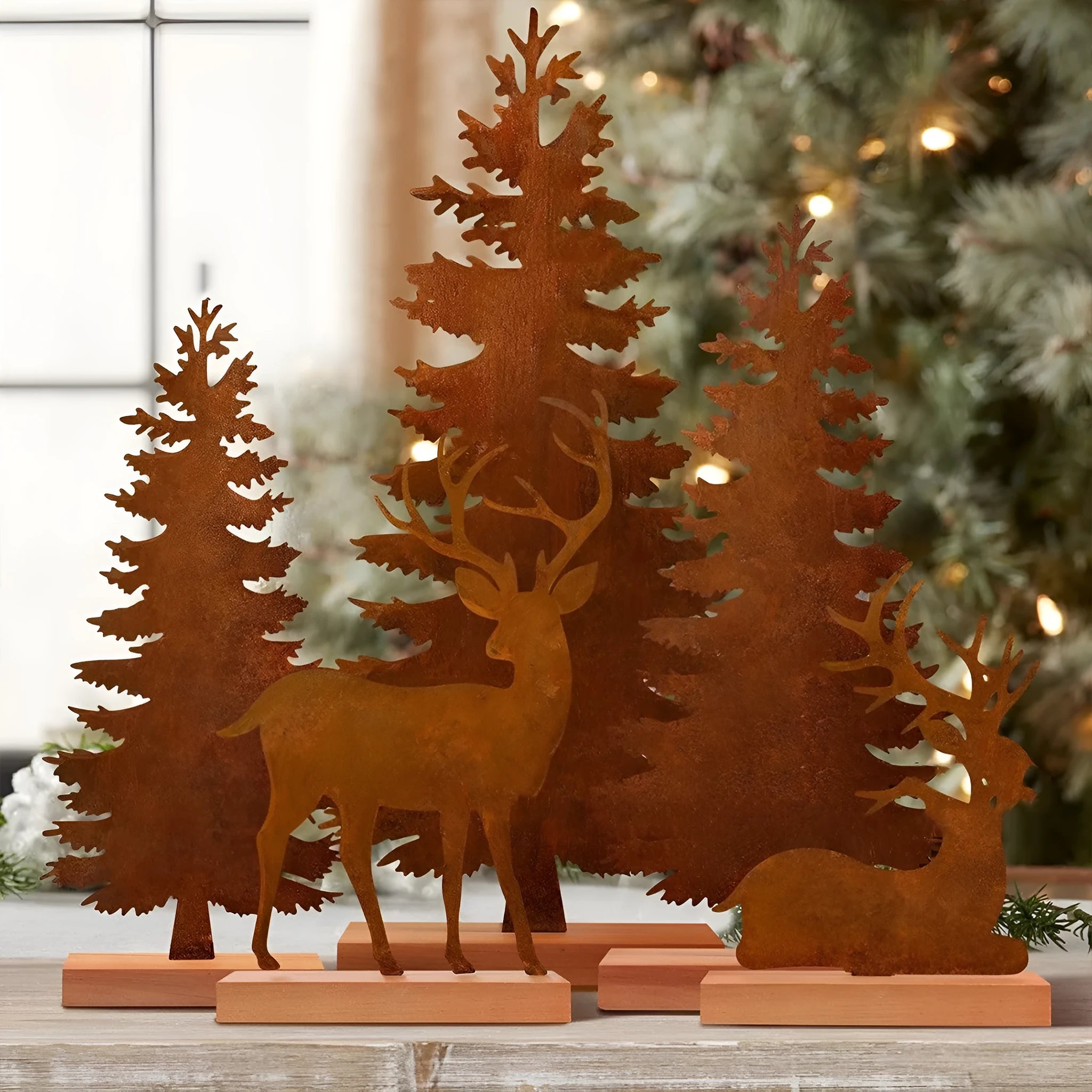 Three rusty metal Christmas tree decorations with elk silhouette cutouts
