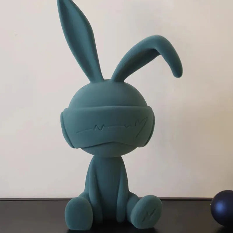 Resin rabbit ornament with suede blindfold in blue, green, or red colour options