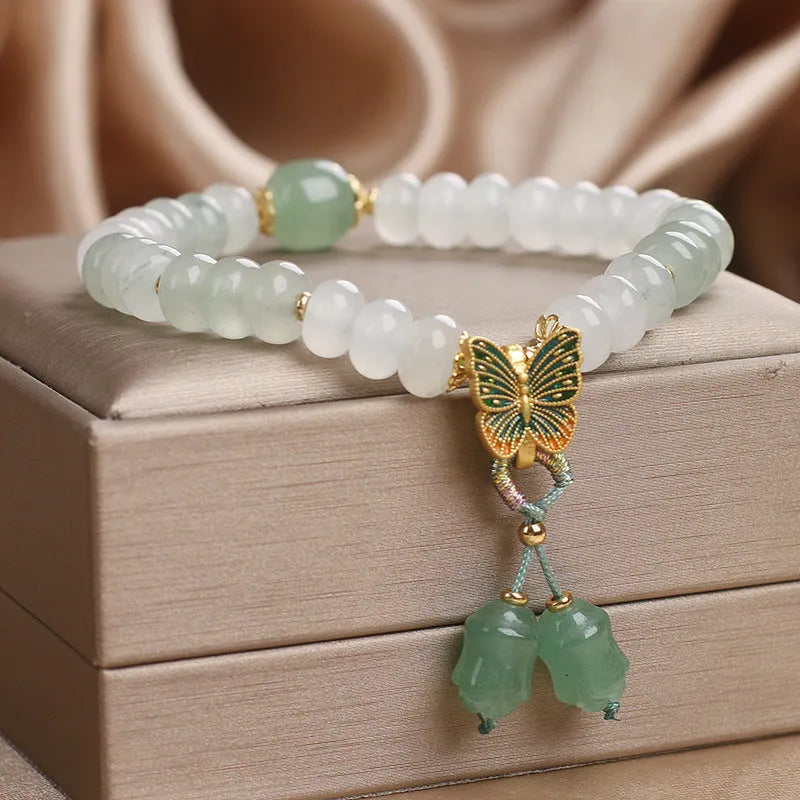 Tian Shan Cui green crystal abacus beads bracelet with butterfly tassel and pearl rhinestone sequin details, 17cm