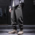 Grey men's straight-leg sweatpants with ankle ties laid flat.