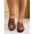 Women's black loafers with bow detail on artificial PU upper, flat sole design