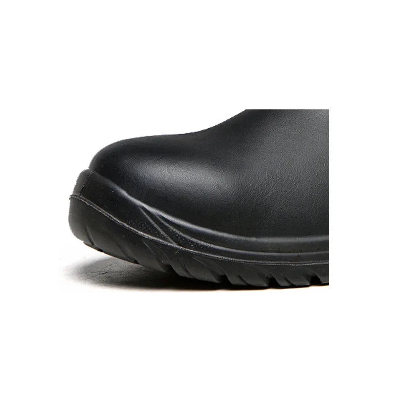 Black high-top leather safety work boots with anti-piercing sole on a workbench.