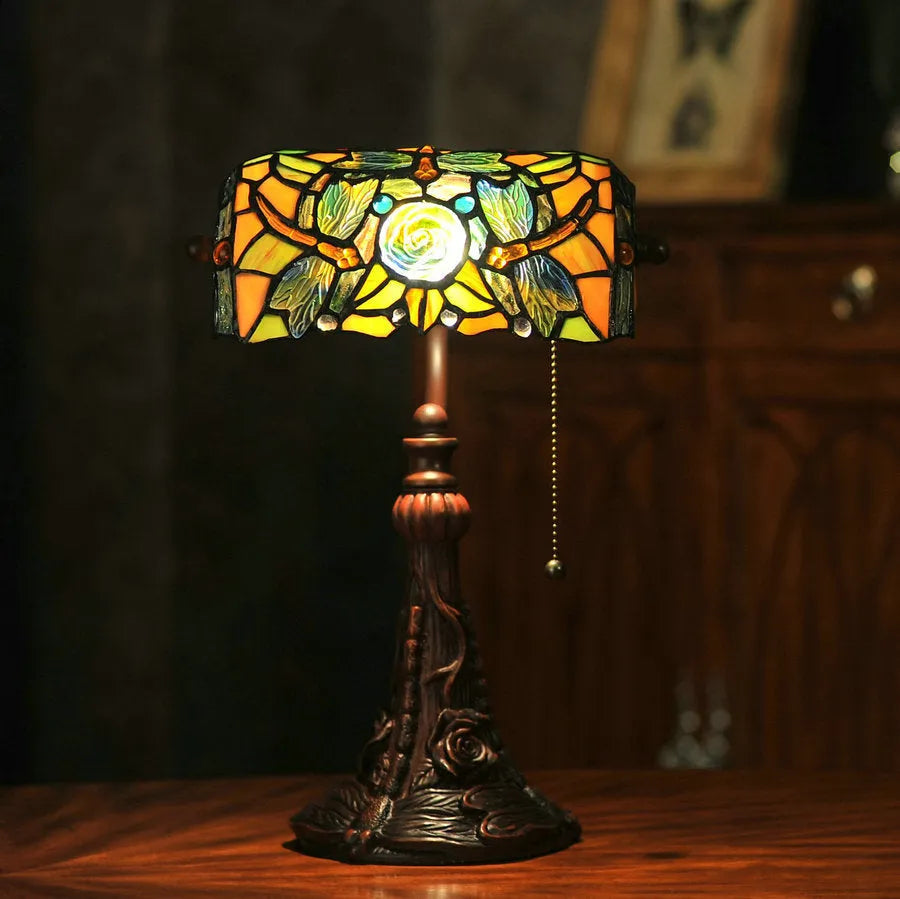 10-inch Tiffany desk lamp with coloured stained glass shade and resin base on a wooden table.