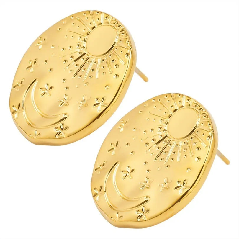 A pair of geometric stainless steel earrings with a small shell detail, shown in gold and silver finish options.