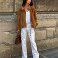 Loose-fit solid colour polyester jacket with long sleeves on a model.