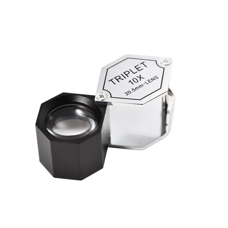 Handheld portable magnifying glass with metal body for jewellery and coin identification.