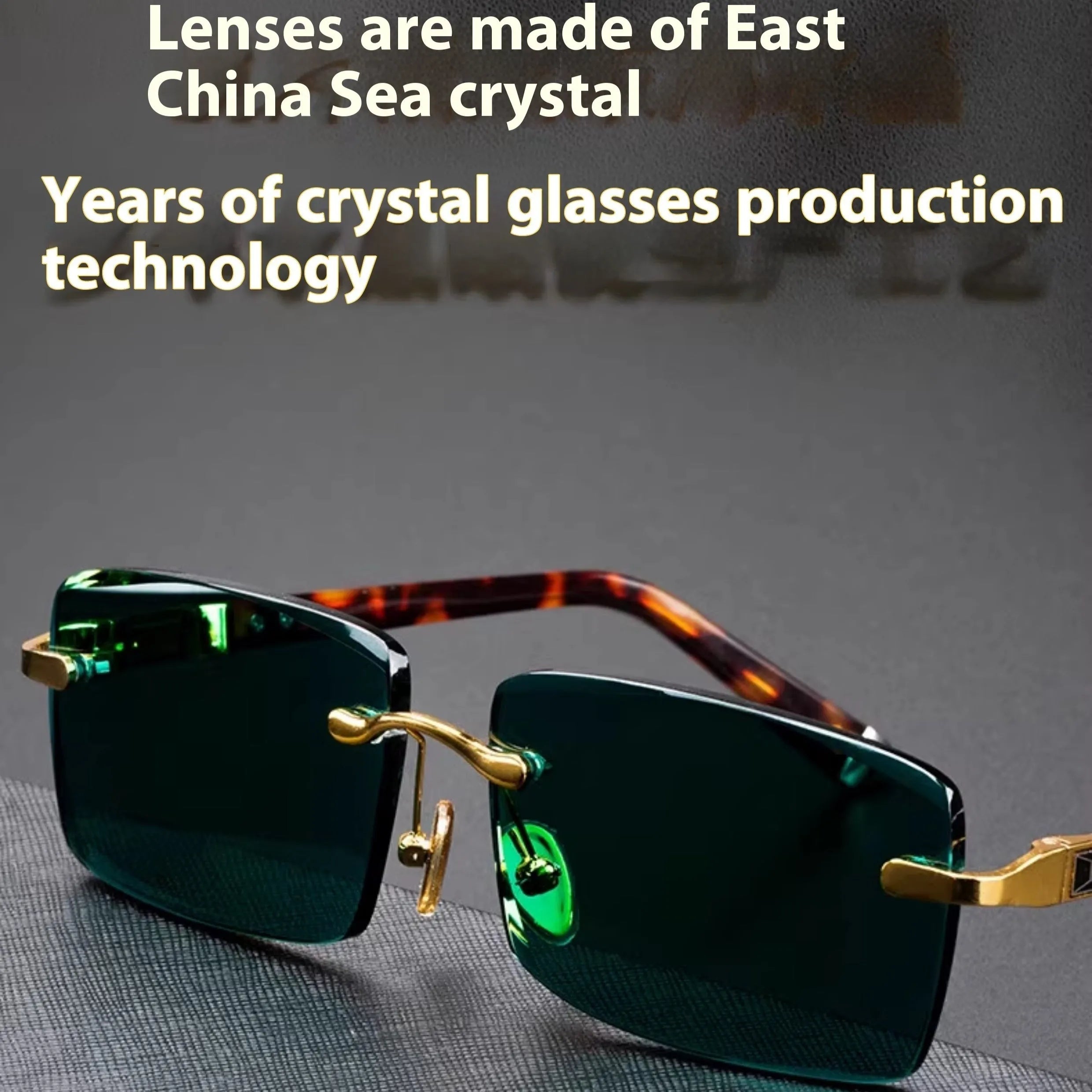 A pair of frameless dark green crystal sunglasses with a hard case and lens cloth.