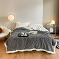 180x200cm thermal polyester blanket in tea green colour on a bed