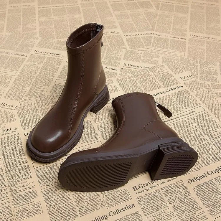 Women's black ankle boots with back zipper, flat thick heel, and round toe design