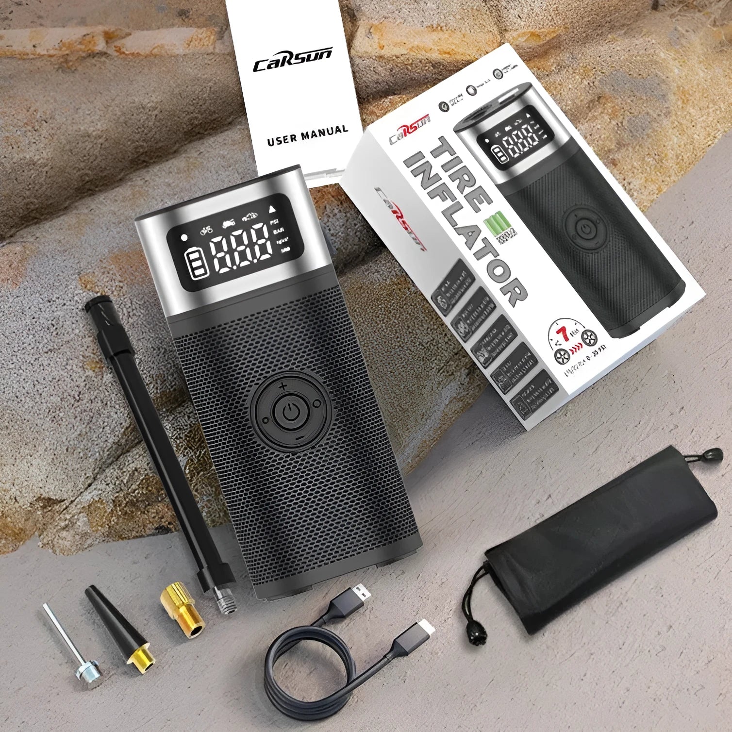 Black portable wireless vehicle air pump with USB charging cable and multiple inflation nozzles including bicycle and ball attachments