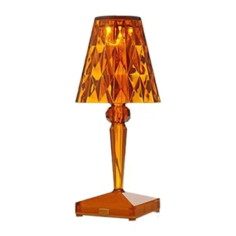 Portable rose gold touch control night light with acrylic lamp holder on a table.