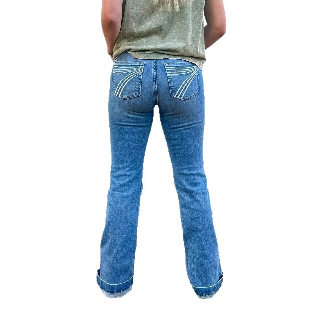 Slim fit blue embroidery jeans with a slight flare and mid-waist on a mannequin.