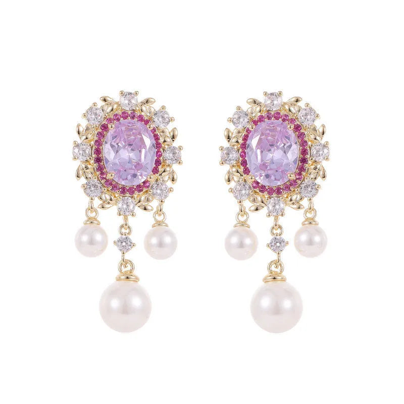 Oval geometric copper drop earrings with inlaid zircon stones, pearl details, and a tassel.