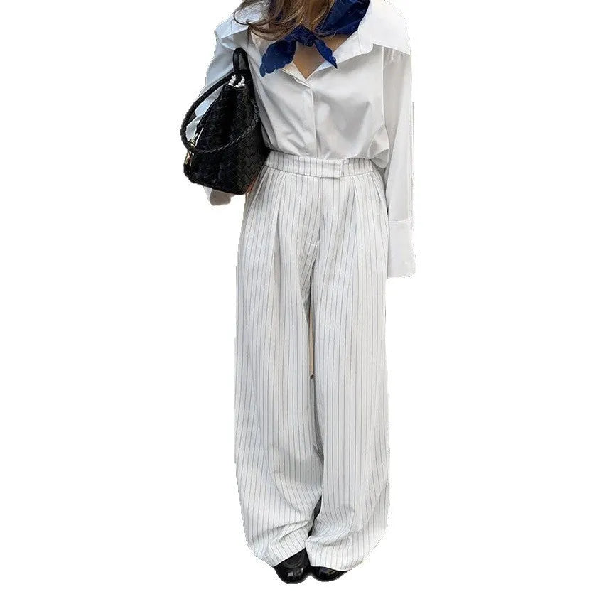 White striped wide-leg trousers with a zip fastening, laid flat.