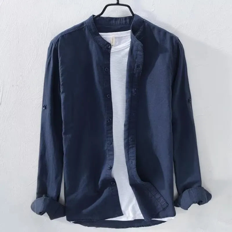 Man wearing a loose-fit light blue linen blend long sleeve casual shirt.