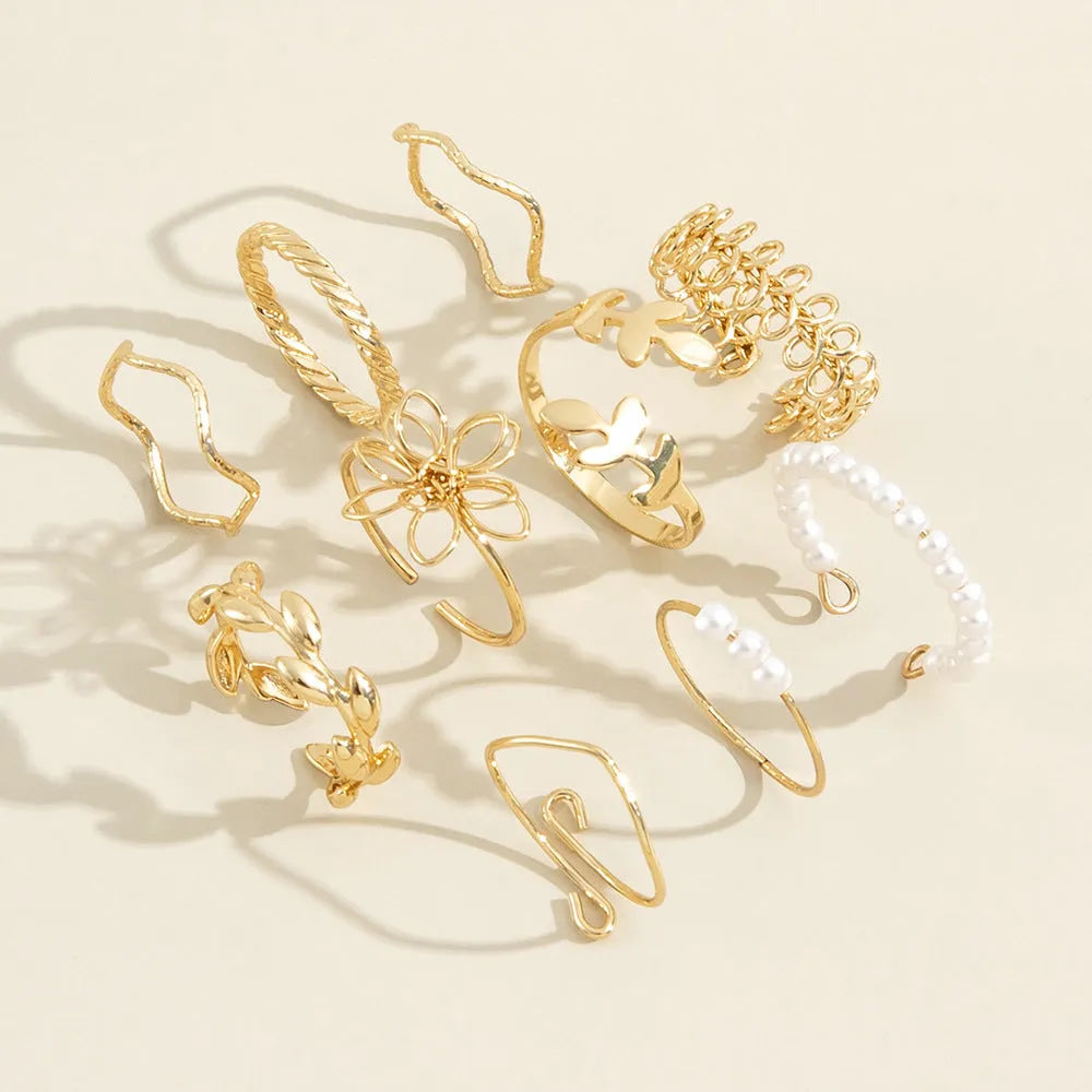 Gold-tone openwork floral ring with a glossy electroplated finish on an alloy band.