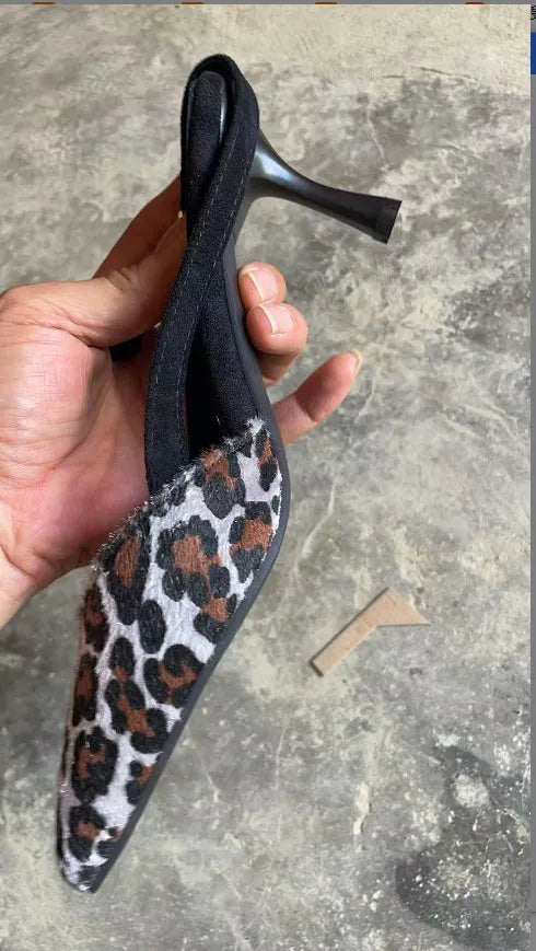 Women's leopard print suede pointed toe high heel sandals on a white background.