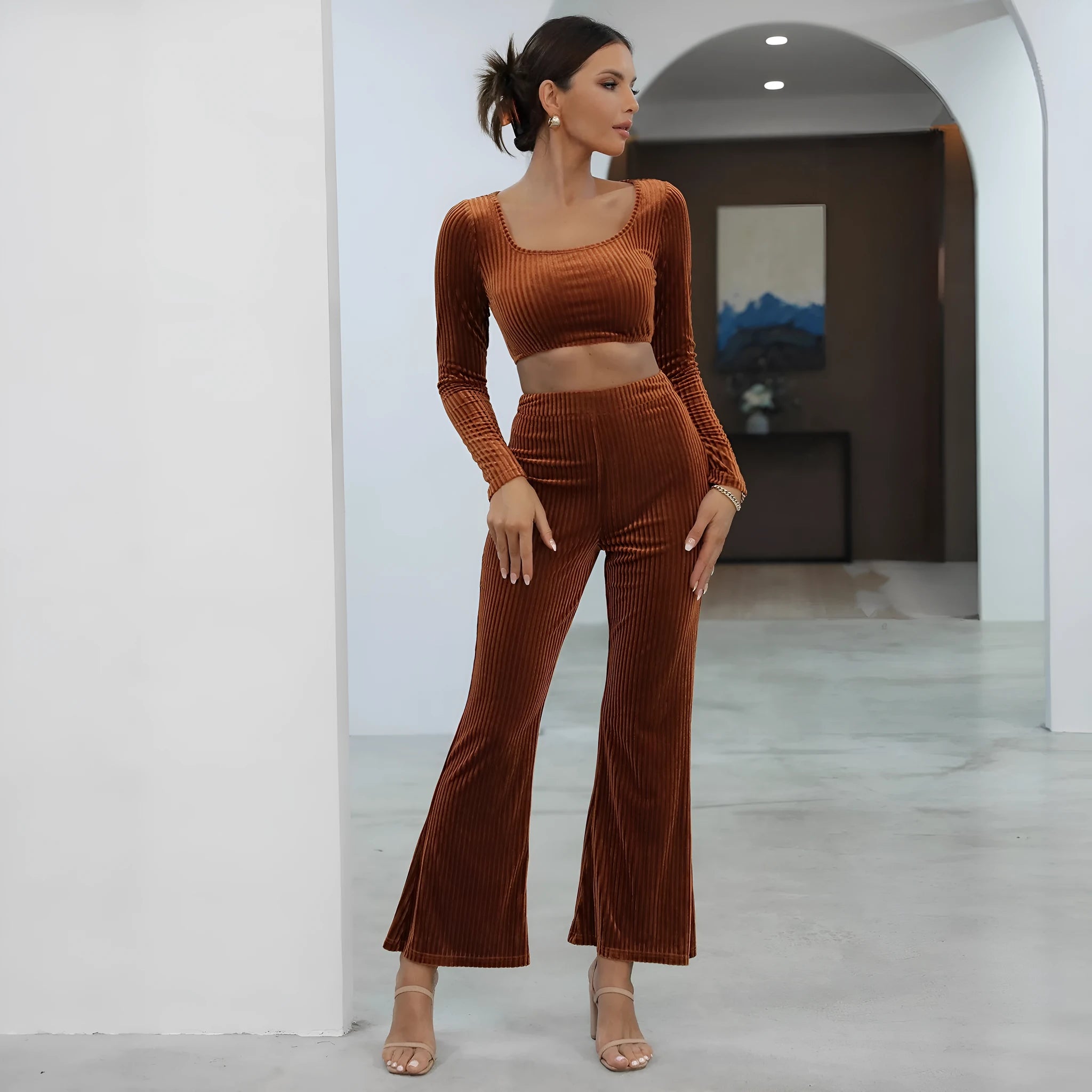 Caramel coloured long sleeve sweater and matching trousers loungewear set on a hanger