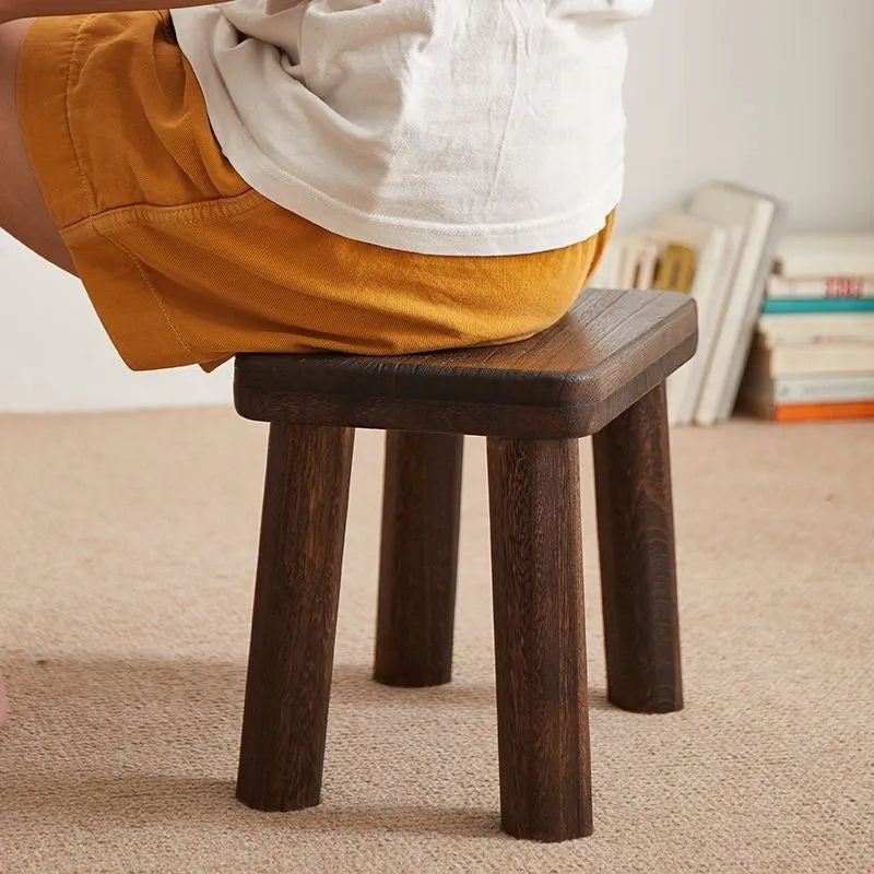 Distressed wooden stool with bracket structure legs in rustic finish