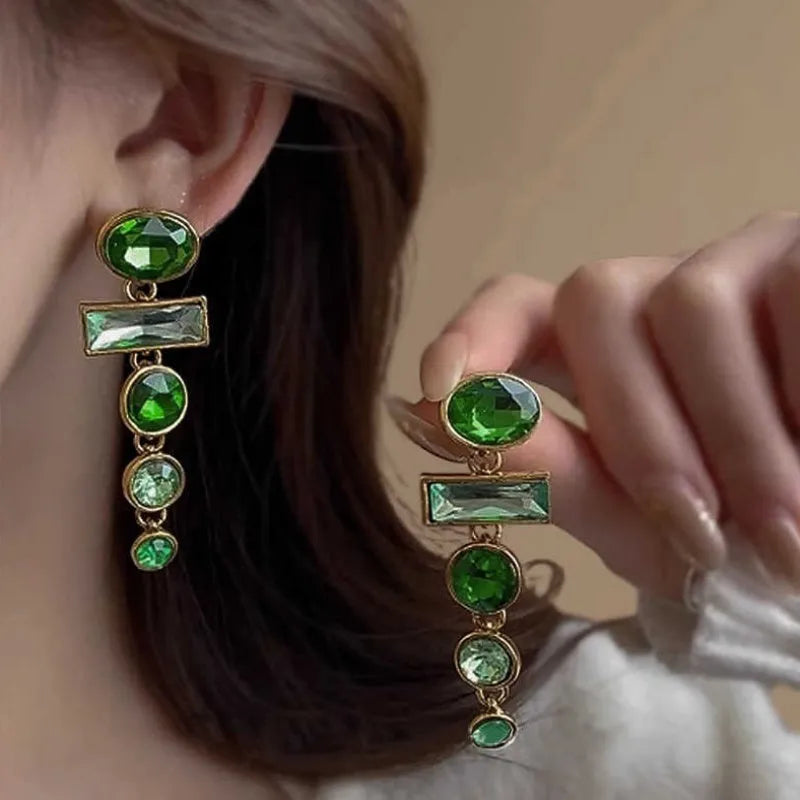 A pair of retro green gradient tassel earrings with inlaid zircon stones in a Chinese geometric style.