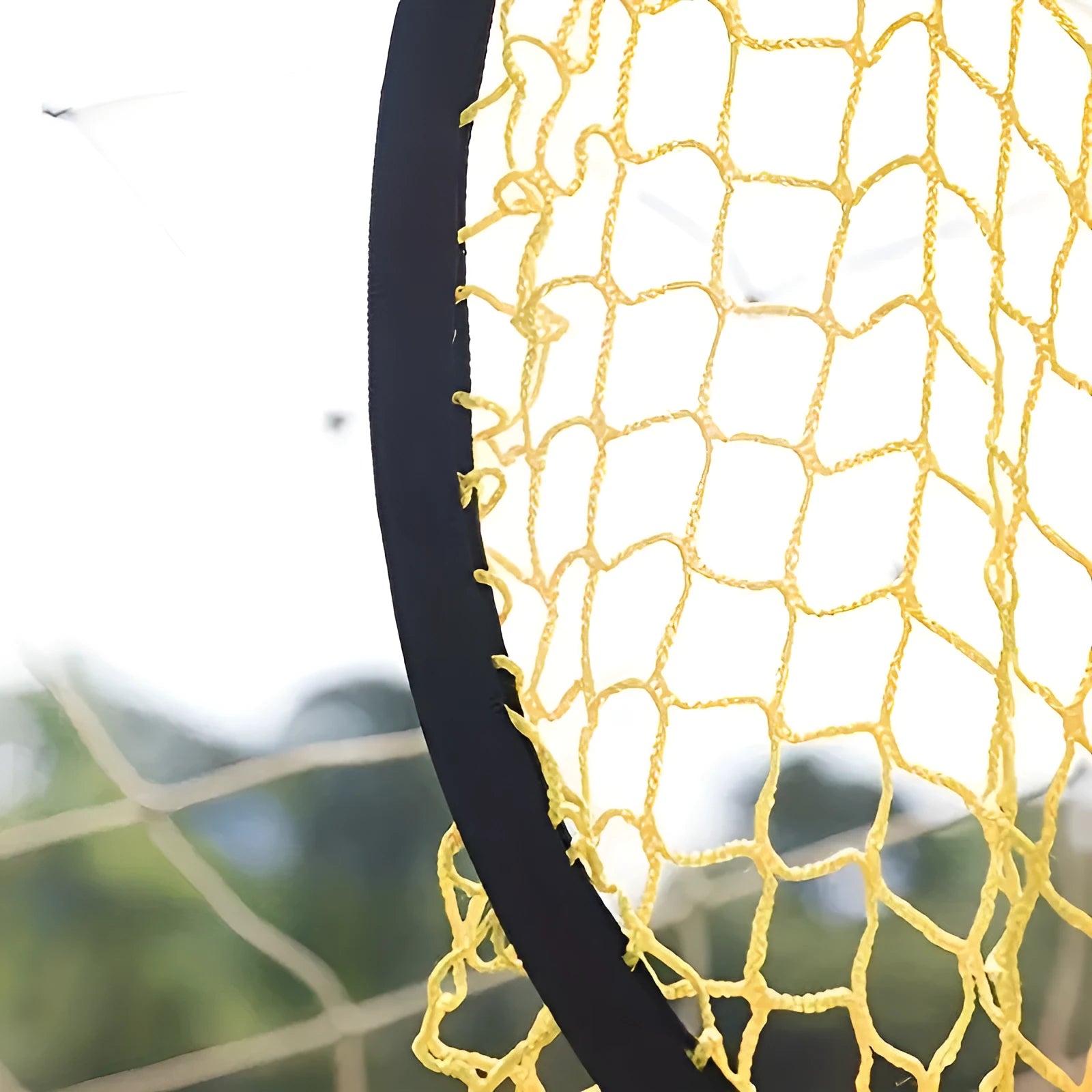 Portable soccer training goal net in black, used for practice shooting drills on grass