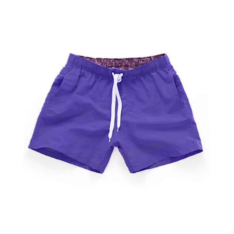 Man wearing soft polyester beach shorts in a straight-leg style, available in multiple colours and plus sizes.