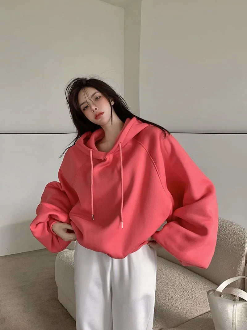 Watermelon red women's sleeveless hooded sweater in mulberry silk fabric on hanger