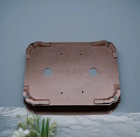 Antique rectangular purple clay flowerpot on a wooden surface with green boxwood plant inside