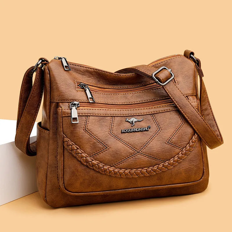 Soft PU leather shoulder bag in horizontal square shape with crossbody strap and multiple compartments